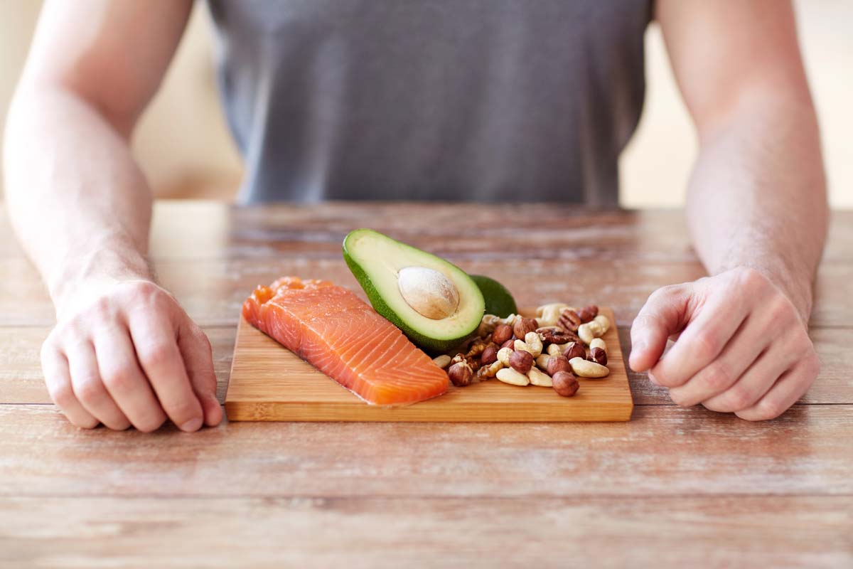 Salmon, avocado and nuts on a chopping board