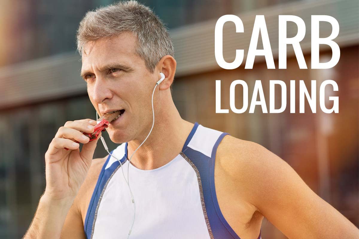 Male runner eating an energy bar before training