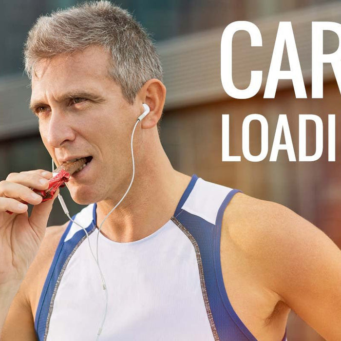 Male runner eating an energy bar before training